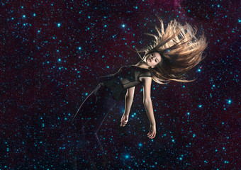 Beautiful, long haired woman falling through stars in space, elements of this image furnished by NASA - 193893139
