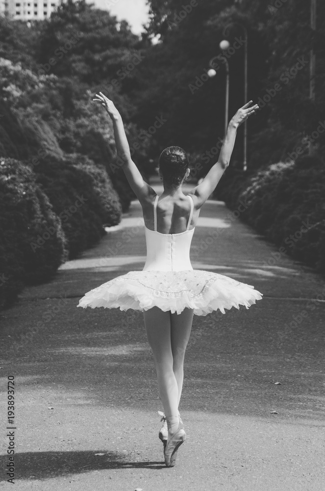 Wall mural ballerina black and white posing in the park