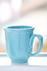 Blue mug with blurred bbackground