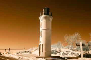 Manning Memorial Lighthouse on sandy Lake Michigan beach  in infrared in winter