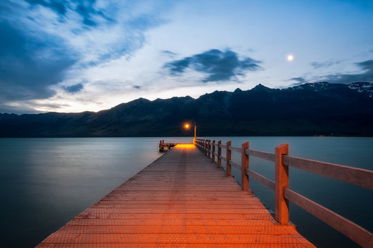 After sunset, the moon is rising at Glenorchy Wharf, New Zealand, South Island.