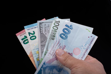 Hand holding American dollar  isolated on black background