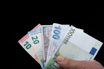 Hand holding American dollar  isolated on black background