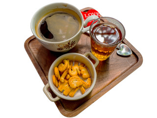 Cup of coffee, Tea and ABC cookies on wooden saucer on table. Isolated on white background including clipping path.