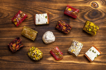 Top view of middle eastern desserts with pistachio, turkish delight and rose petals