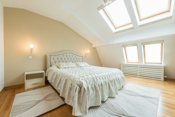 Interior of a luxury loft bedroom with master bed