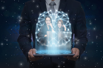 Businessman holding the tablet showing the brain with futuristic screen hologram showing two businesswoman over the Innovation Technology background, technology and healthy concept