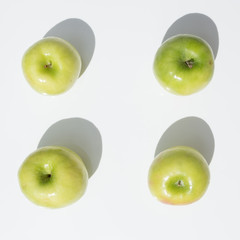 top view of four green Granny Smith apples