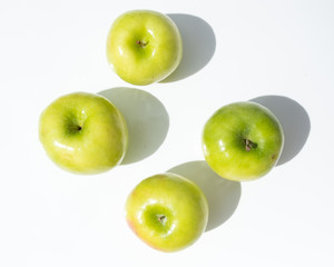 top view of four green Granny Smith apples