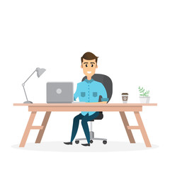 smiling businessman is sitting and working on a laptop computer in his office