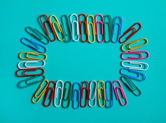 Fototapeta premium colorful paperclip on blue pastel background