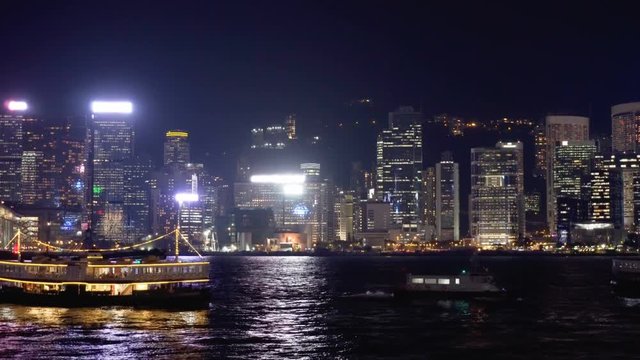Hong Kong skyline at night. Boats crossing Victoria Harbor