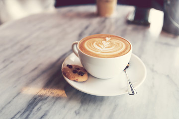 Soft focus on A cup of hot coffee (Latte) on table.