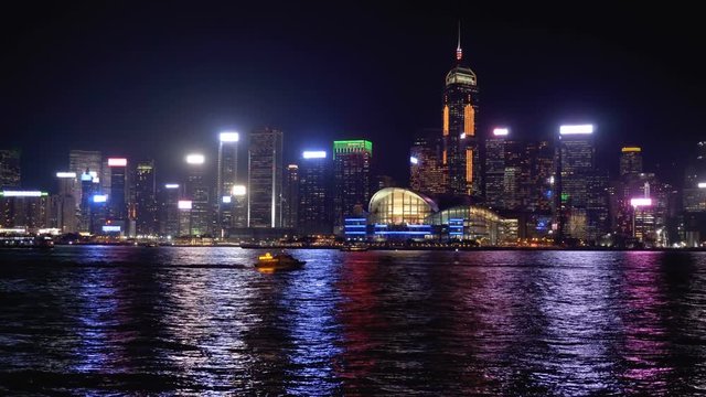 Hong Kong skyline at night. Boats crossing Victoria Harbor
