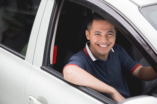 asian driver smiling to camera