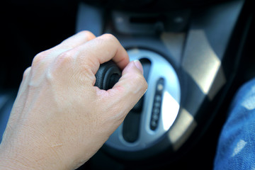 Hand of men on control automatic gear 