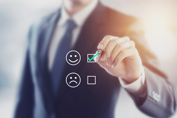 Businessman giving rating with happy icon, Customer satisfaction survey concept