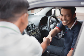 man driver shake hand