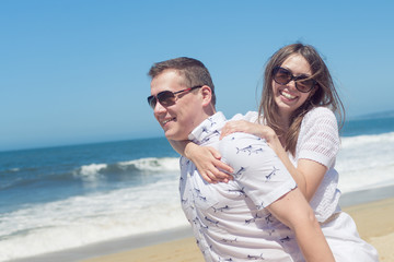 Young romantic couple hugging on the beach