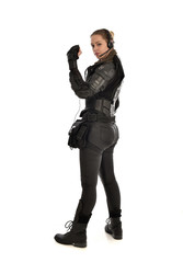 full length portrait of female  soldier wearing black  tactical armour  facing away from camera, isolated on white studio background. © faestock