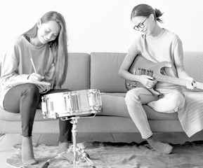 Women playing music together at home