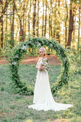 Fototapeta na wymiar Wedding arch. Beautiful bride.