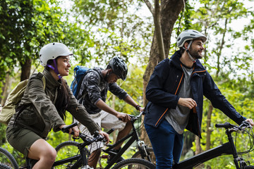 Fototapeta premium Group of friends ride mountain bike in the forest together