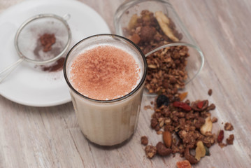 Top view of Glass of Milk with Granola Cereals with Dried Fruits overRustic Wodden Board. Healthy Food Breakfast.