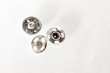Cufflinks are placed on a white background.