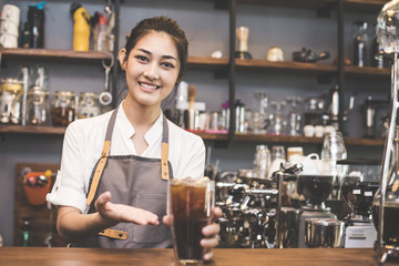 Asian Barista woman making Coffee with coffee machine in the coffee shop. people with barista in cafe concept. Vintage tone.