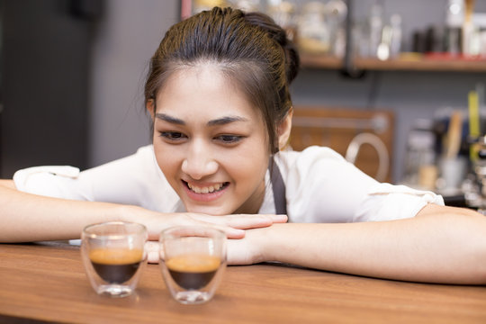 Asian Barista woman making Coffee in the coffee shop. people with barista in cafe concept.