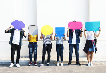 Naklejka premium Young adult friends holding up copyspace placard thought bubbles