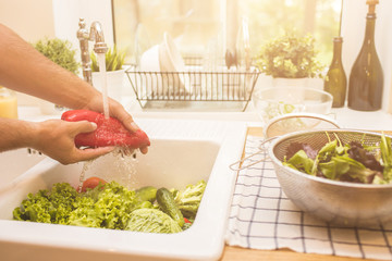 Man washing vegetables before eating