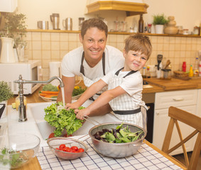 Man and boy washing vegetables before eating