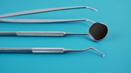 Professional Dentist tools in dental office: dentist mirror, forceps curved, explorer curved, dental explorer angular and explorer curved with chip, right. Dental Hygiene and Health conceptual image