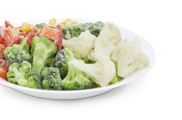 Various frozen vegetables on the white dish closeup