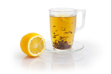 Glass cup of black tea with flowers additive and lemon