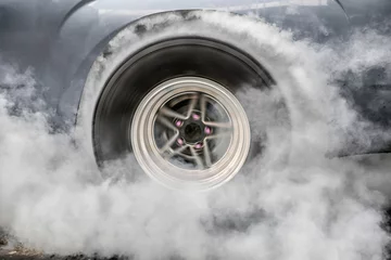 Küchenrückwand glas motiv Drag racing car burns rubber off its tires in preparation for the race © toa555