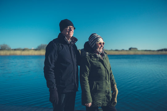 Senior couple by the water in winter
