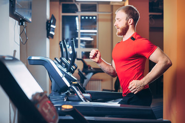 the athlete runs on a treadmill in the gym