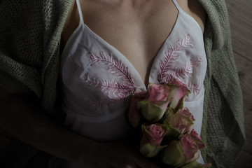 Detail of cleavage with bouquet of roses