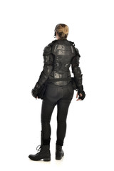 full length portrait of female  soldier wearing black  tactical armour  facing away from camera, isolated on white studio background.