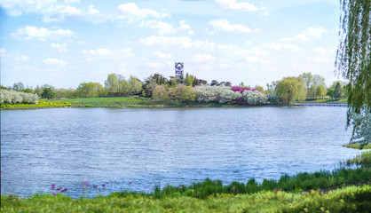 Fototapeta na wymiar small lake and blue sky with colorful trees