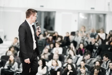 speaker conducts the business conference for journalists and aspiring entrepreneurs