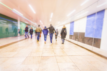 Crowd of anonymous people walking on busy metro station 