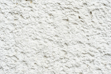 Close-up Deep texture of white-painted porous stone on the facade of the building. Stoned wall background texture