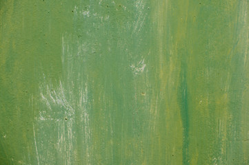 Textured metal surface carelessly colored green paint and faded in the sun in pale gray with rusty...