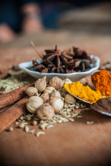 Various spices and herbs on wooden table