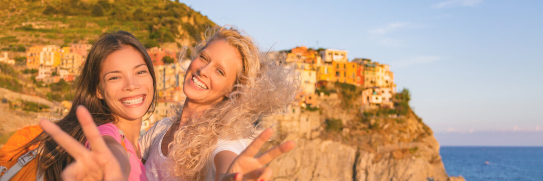 Travel tourists girls friends having fun hiking in Cinque Terre , Italy summer vacation. Happy girlfriends backpacking through Europe laughing banner panorama.