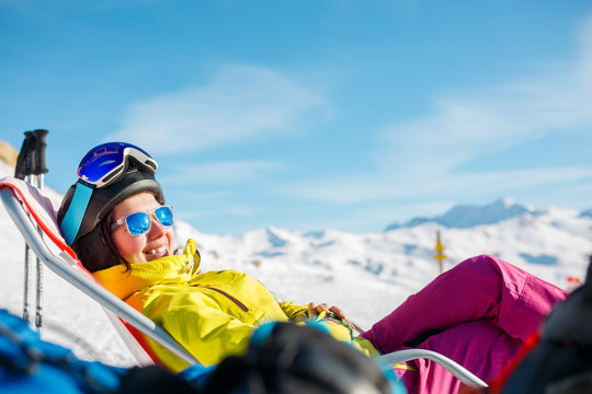 Photo of smiling sports woman lying on winter deckchair